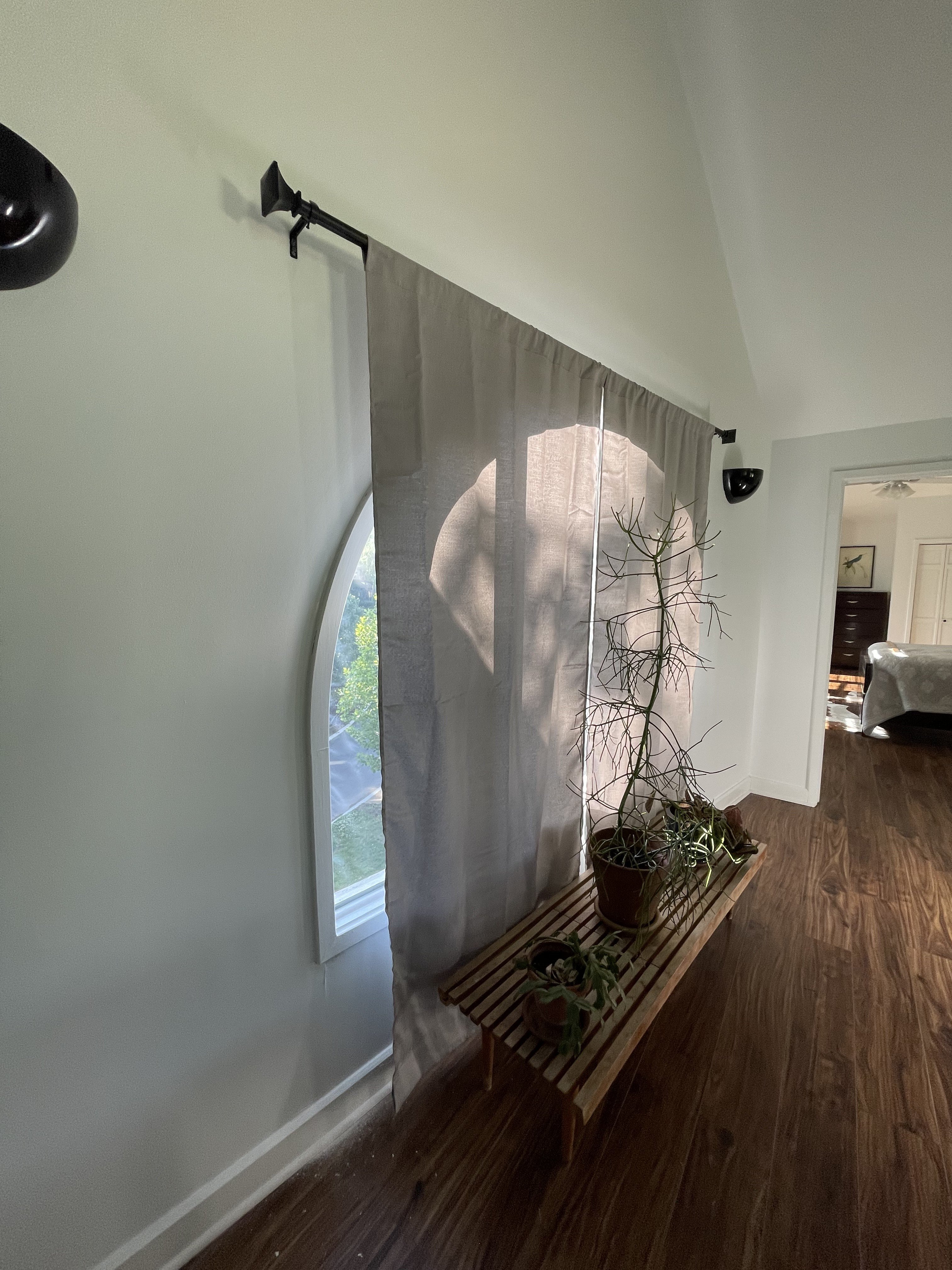 Arched window after curtain installation